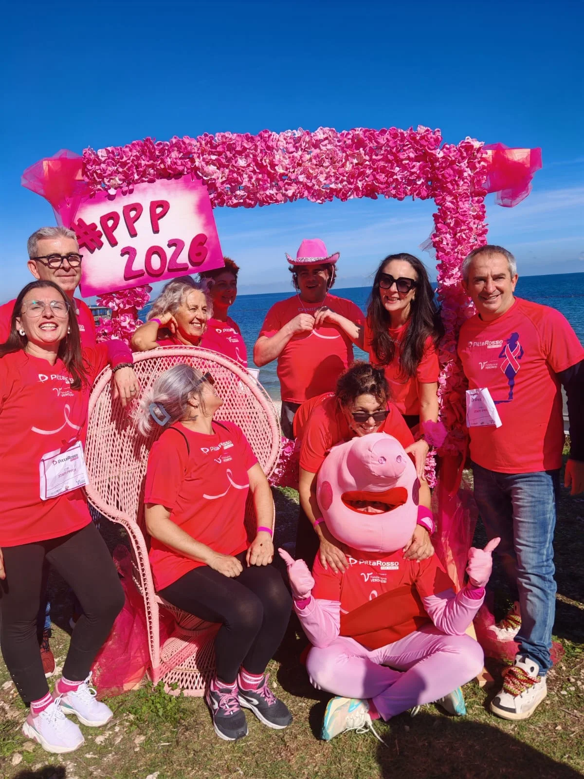 A group of participants in the pink photo area