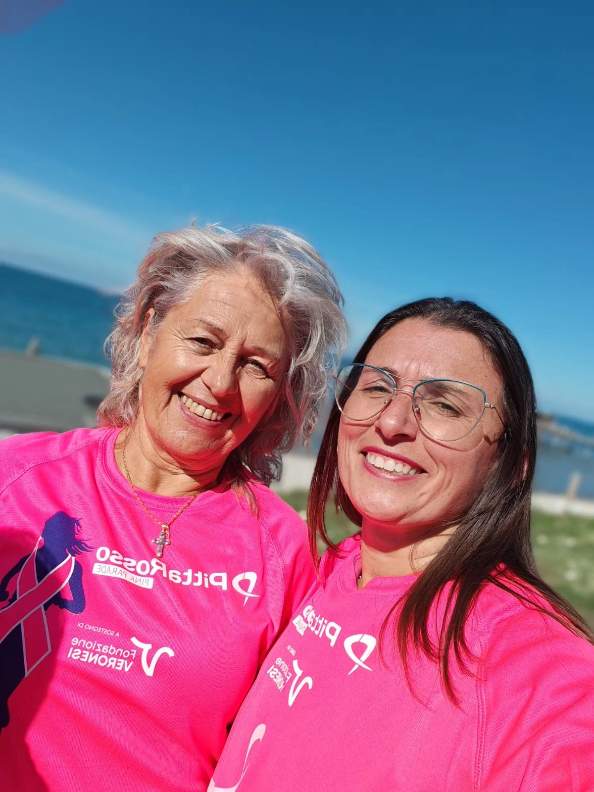 Two participants wearing pink by the sea
